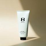 White tube of 'ONE SKIN' topical supplement on a beige background