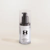 Clear bottle with black pump and 'One Skin' label on a light beige background