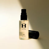 Skincare bottle labeled 'ONE SKIN' on a beige background